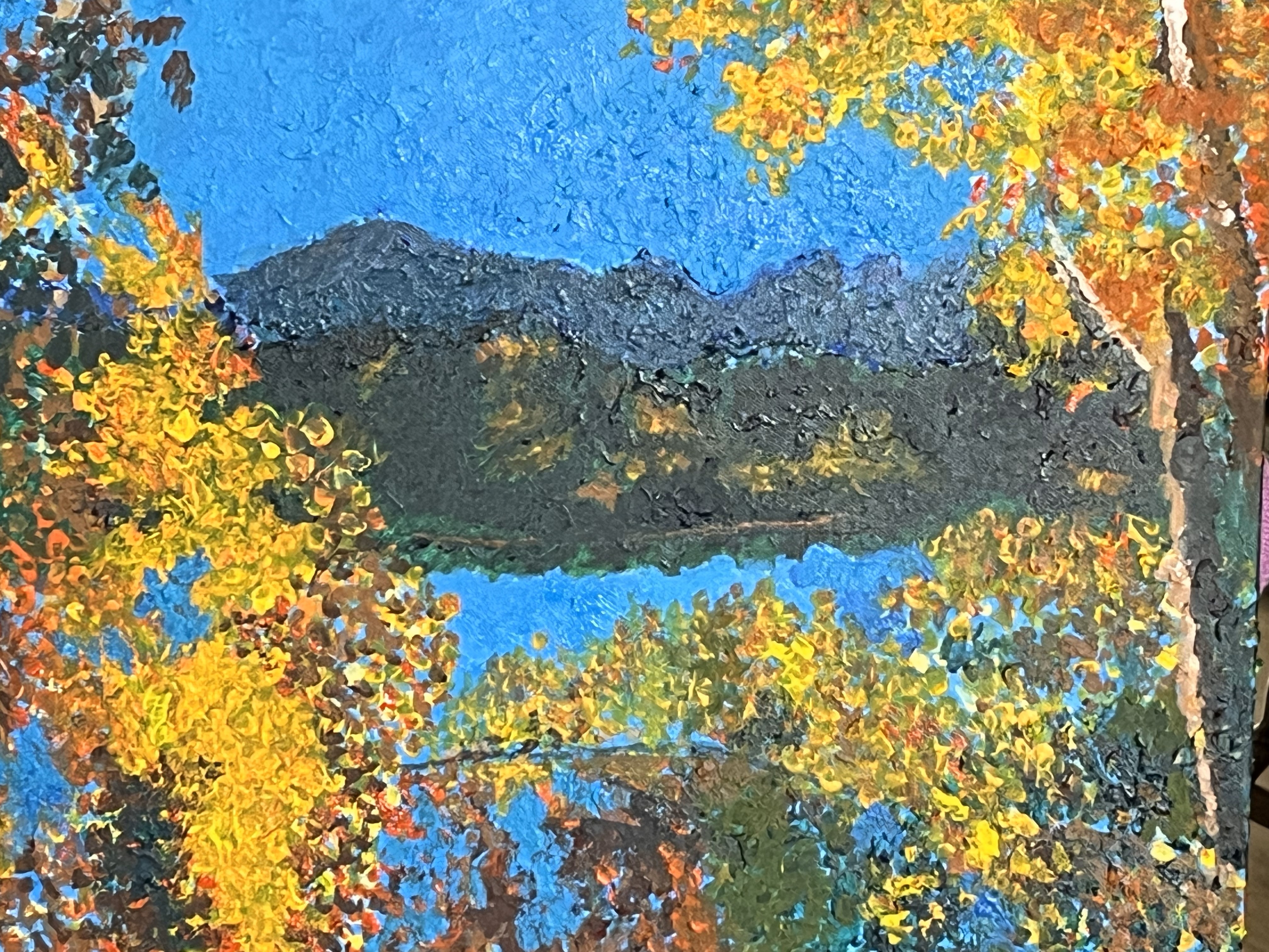 A cluster of aspens next to a lake